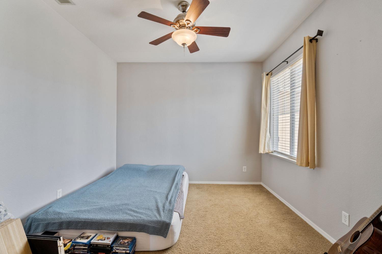 3915 Harlan Ranch Boulevard Clovis, CA 93619 - Photo 18 of 27 an empty room with windows and fan