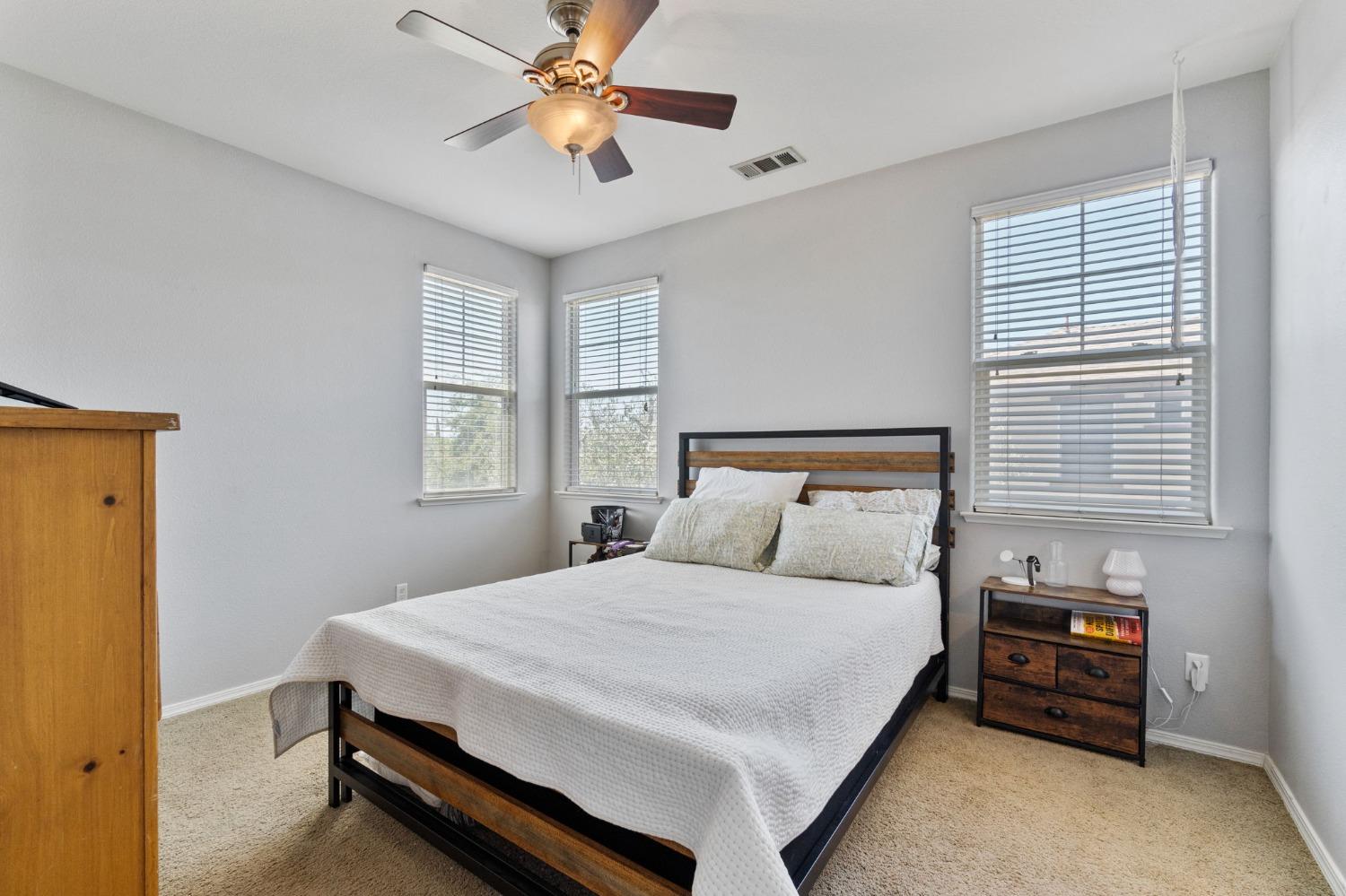 3915 Harlan Ranch Boulevard Clovis, CA 93619 - Photo 21 of 27 a bedroom with a bed and a chandelier