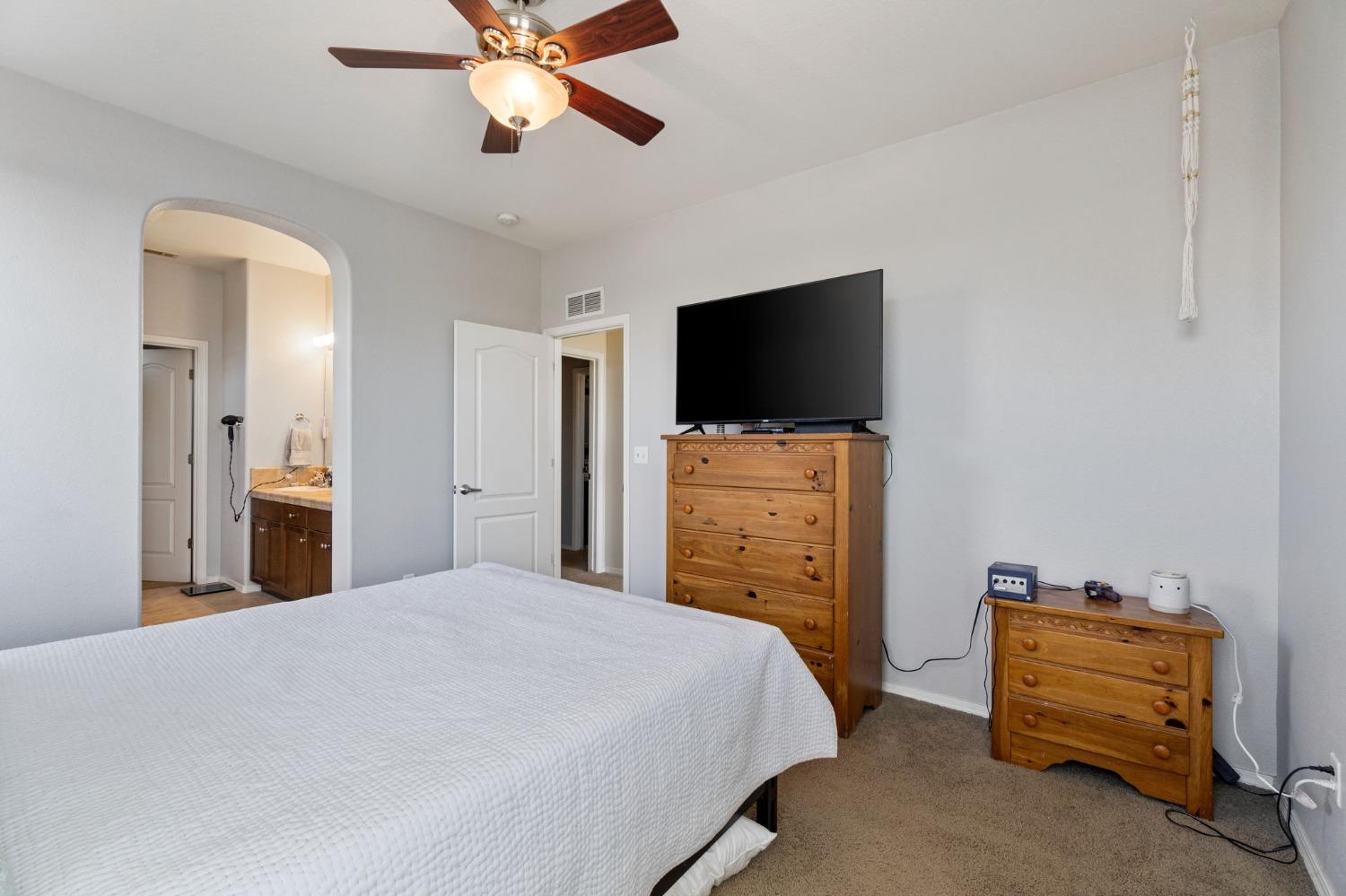 3915 Harlan Ranch Boulevard Clovis, CA 93619 - Photo 22 of 27 a bedroom with a bed and a flat screen tv