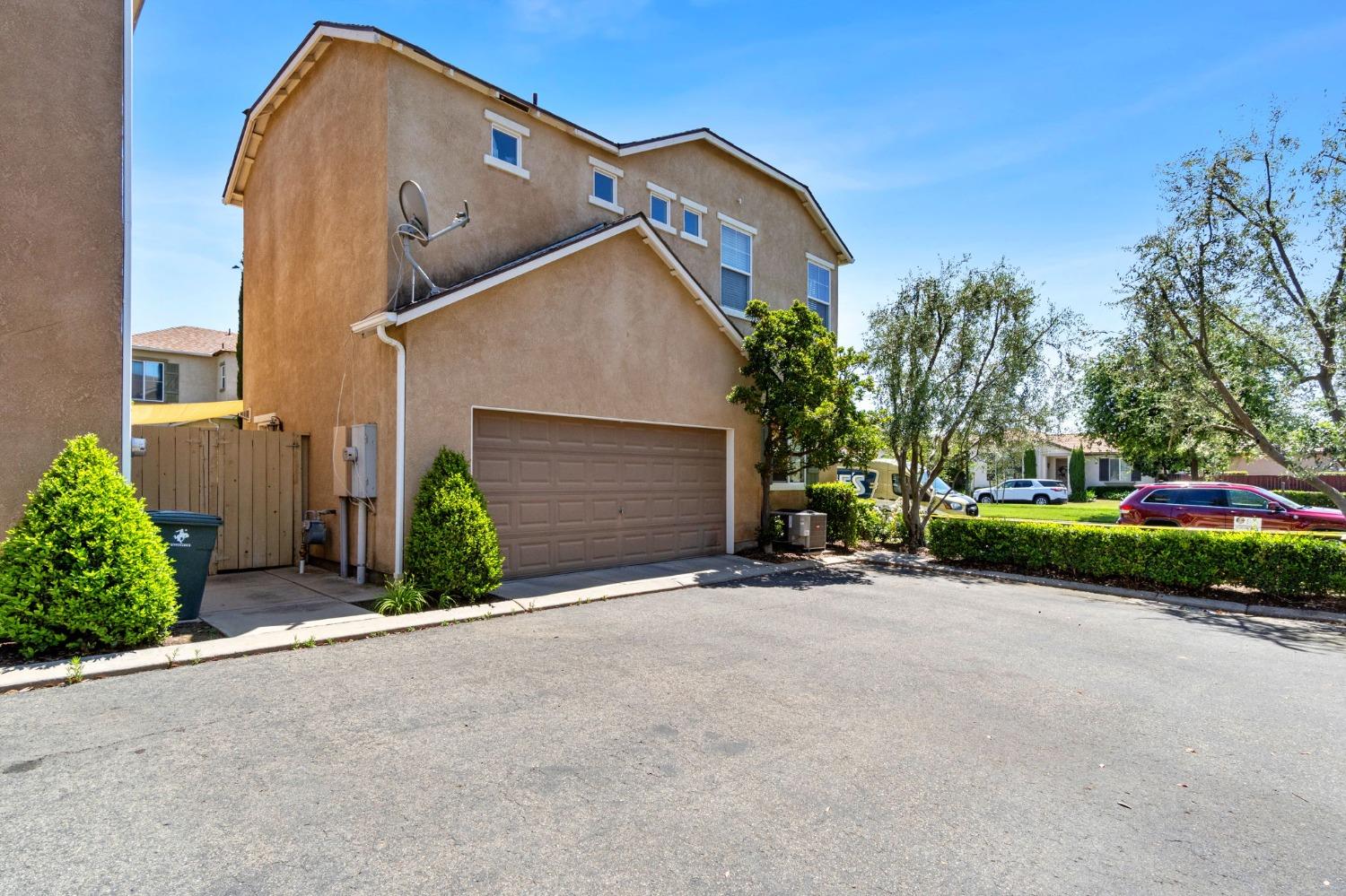 3915 Harlan Ranch Boulevard Clovis, CA 93619 - Photo 27 of 27 a view of a house with a yard and garage