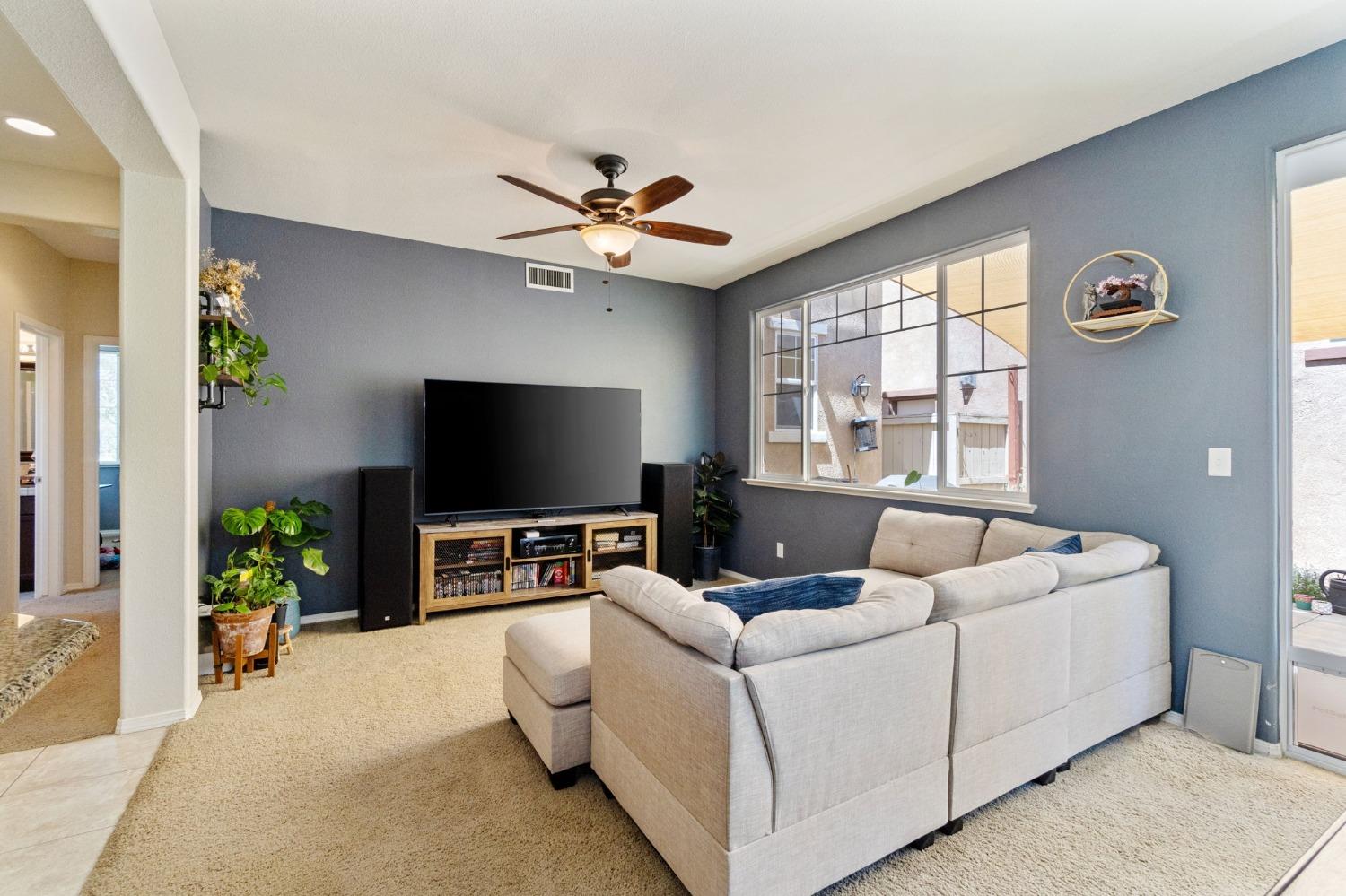 3915 Harlan Ranch Boulevard Clovis, CA 93619 - Photo 4 of 27 a living room with furniture and a flat screen tv