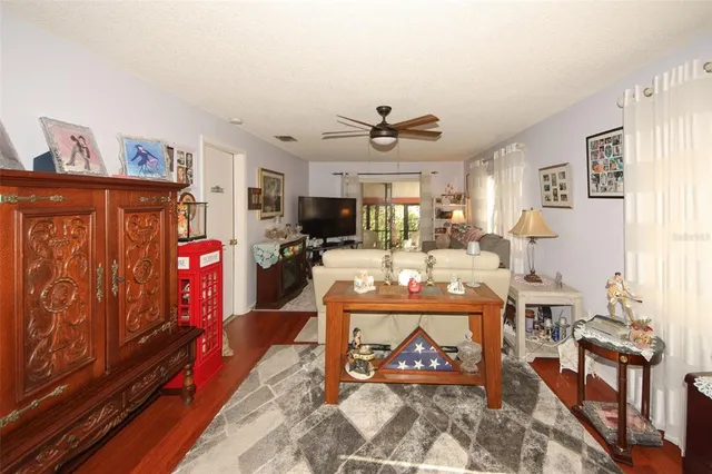 a living room with furniture a flat screen tv and a window