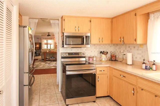 a kitchen with a sink cabinets and appliances