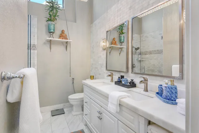 a bathroom with a sink a toilet and shower curtain