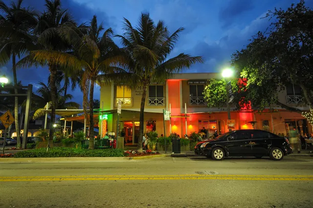 a view of a street with cars parked
