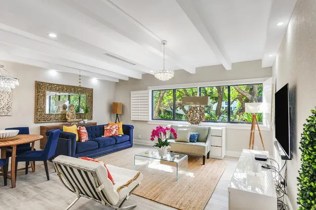 a living room with patio furniture and a large window