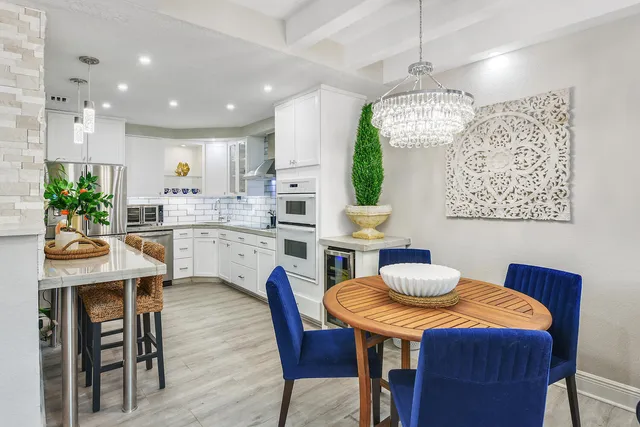 a dining room with wooden floor and stainless steel appliances