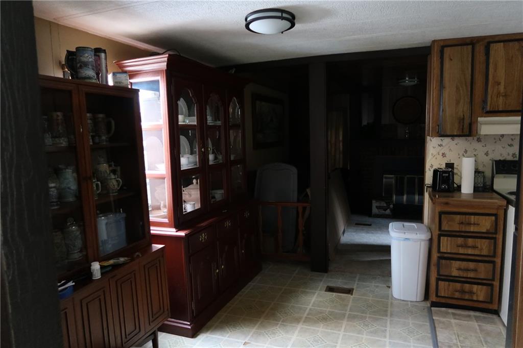 117 Esposito Road Mercer, PA 16137 - Photo 12 of 32 a kitchen with a refrigerator and cabinets