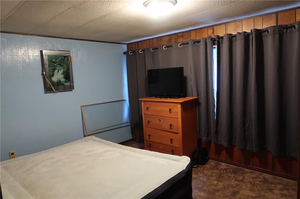 117 Esposito Road Mercer, PA 16137 - Photo 16 of 32 a bedroom with a bed and a flat tv screen on the dresser