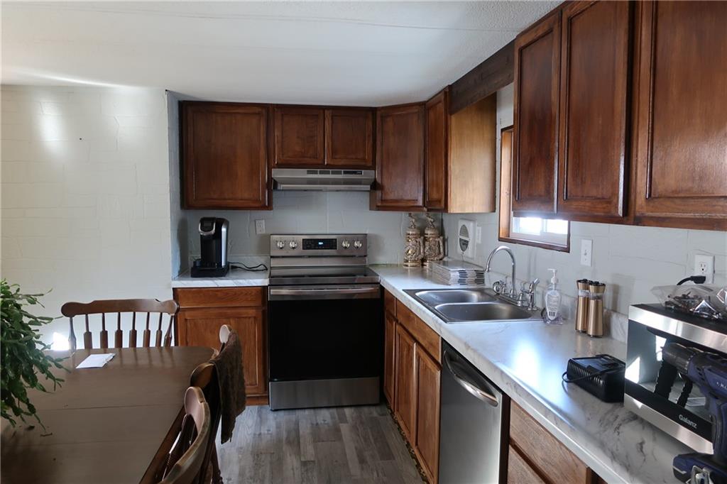117 Esposito Road Mercer, PA 16137 - Photo 19 of 32 a kitchen with stainless steel appliances a sink a stove a refrigerator cabinets and a counter space