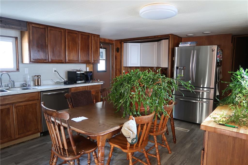 117 Esposito Road Mercer, PA 16137 - Photo 21 of 32 a kitchen with a table chairs refrigerator and microwave