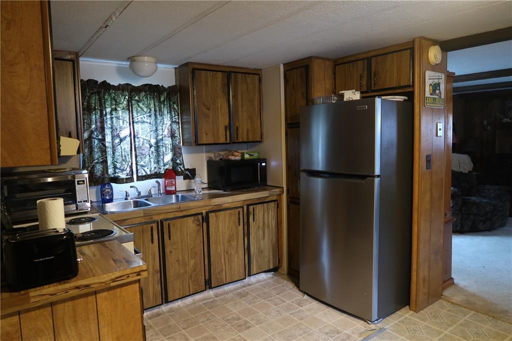 117 Esposito Road Mercer, PA 16137 - Photo 8 of 32 a kitchen with a refrigerator and a sink