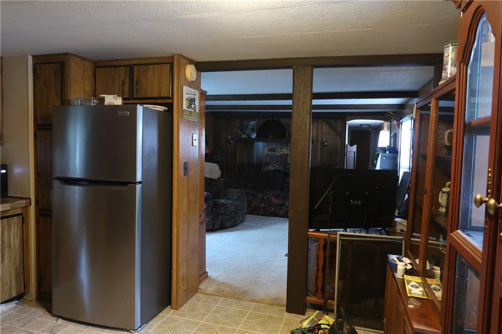 117 Esposito Road Mercer, PA 16137 - Photo 9 of 32 a kitchen with a refrigerator and cabinets