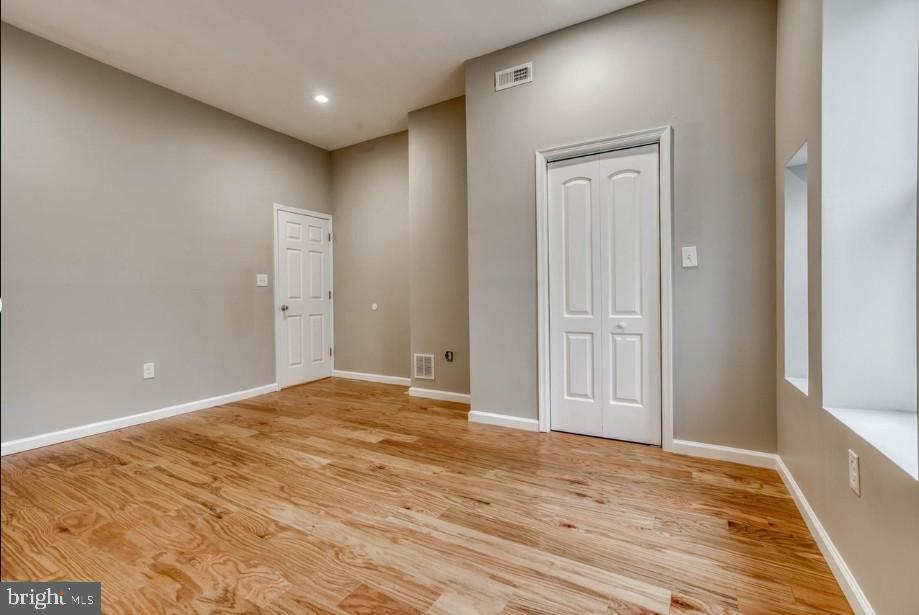 2409 Barclay Street Baltimore, MD 21218 - Photo 11 of 23 Spacious room with warm wood flooring.
