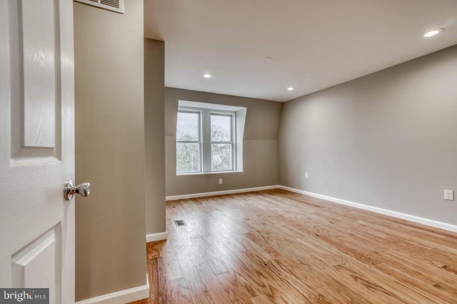 2409 Barclay Street Baltimore, MD 21218 - Photo 14 of 23 Bright, airy space with hardwood floors.