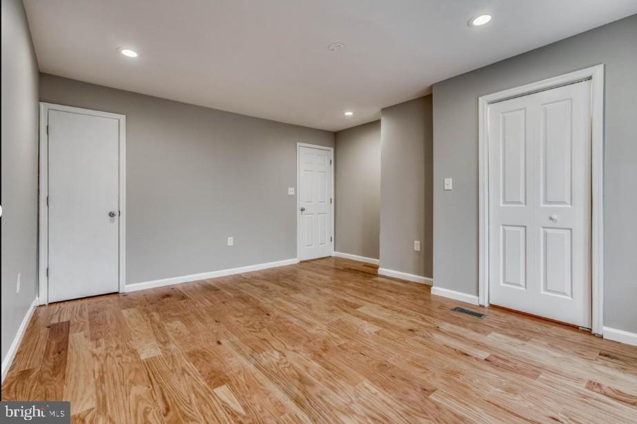 2409 Barclay Street Baltimore, MD 21218 - Photo 15 of 23 Spacious, modern room with warm wood floors.