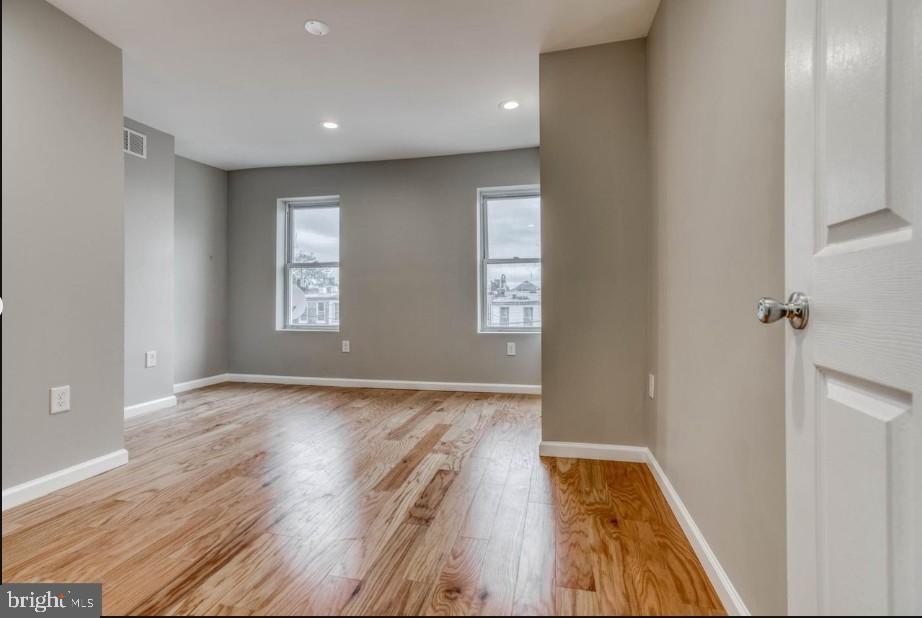 2409 Barclay Street Baltimore, MD 21218 - Photo 16 of 23 Bright and airy space with hardwood floors.
