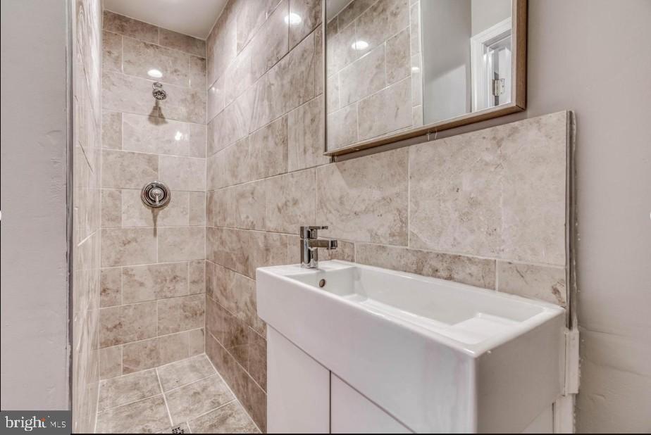 2409 Barclay Street Baltimore, MD 21218 - Photo 18 of 23 Sleek modern bathroom with elegant tiles.