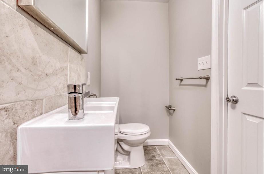 2409 Barclay Street Baltimore, MD 21218 - Photo 19 of 23 Sleek and modern bathroom with elegant finishes.
