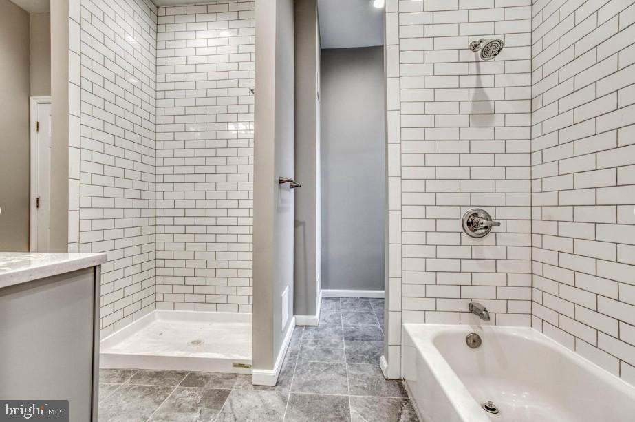 2409 Barclay Street Baltimore, MD 21218 - Photo 8 of 23 Modern bathroom with sleek tile design.