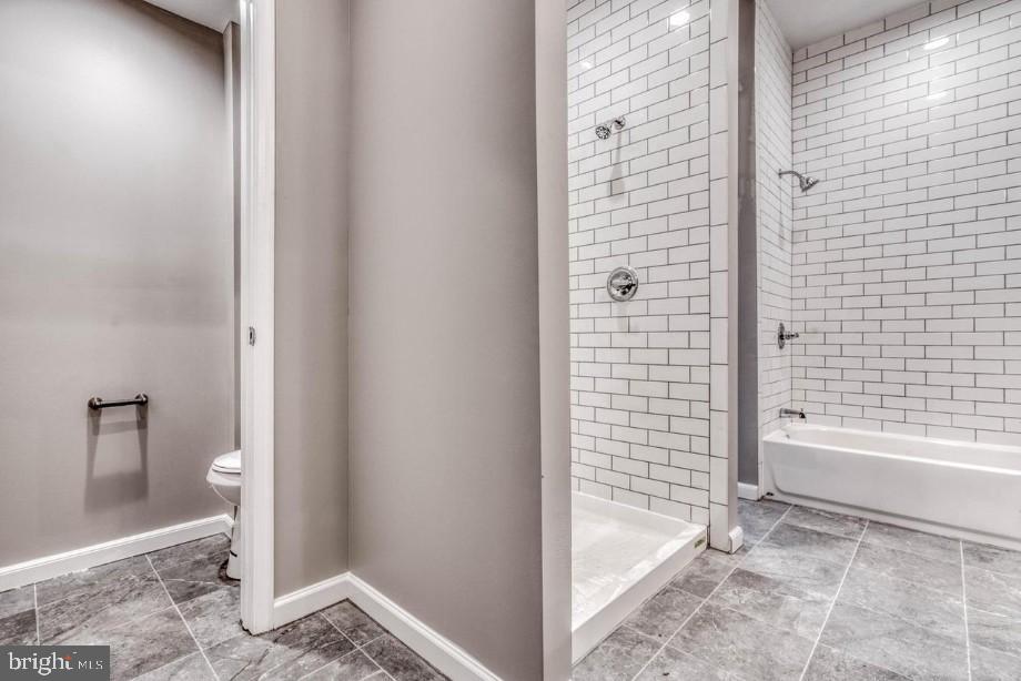 2409 Barclay Street Baltimore, MD 21218 - Photo 10 of 23 Modern bathroom with sleek tile design.
