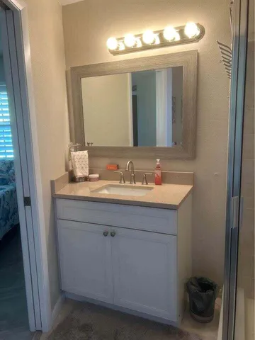 a bathroom with a sink vanity and a mirror