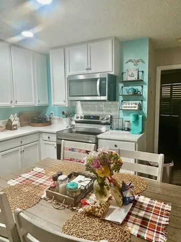 a kitchen with stainless steel appliances granite countertop a sink and cabinets