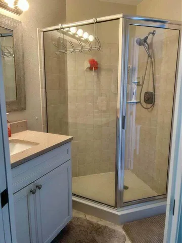 a bathroom with a shower and a sink