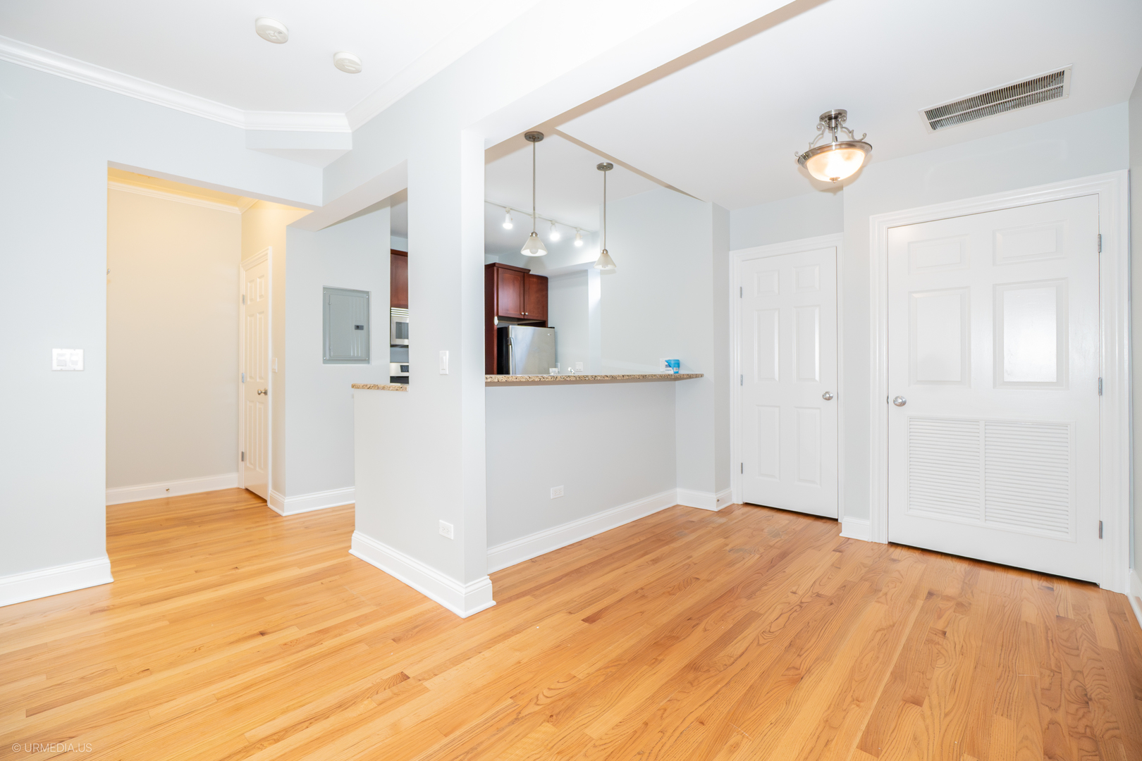 2608 West Leland Avenue, Unit 3 Chicago, IL 60625 - Photo 4 of 20 a view of empty room with wooden floor and fan
