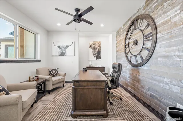 a view of living room kitchen with stainless steel appliances granite countertop furniture and a flat screen tv