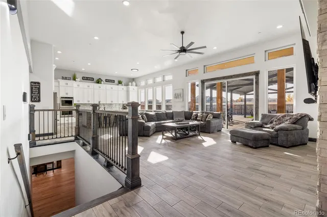a living room with furniture and a ceiling fan