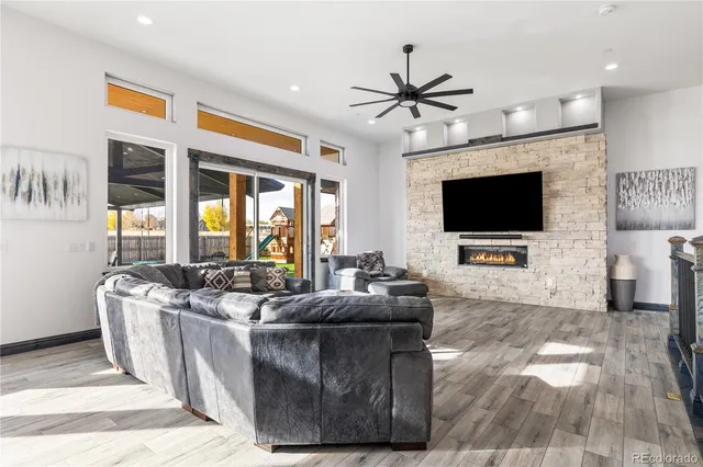 a living room with furniture a fireplace and a flat screen tv