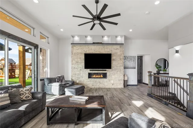 a kitchen with granite countertop a table chairs stove and white cabinets