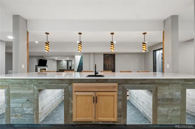 a view of a kitchen with furniture and wooden floor