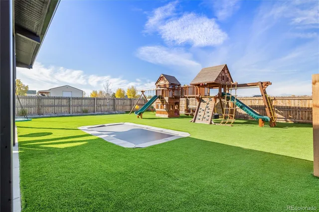 a view of outdoor space with playground and green space