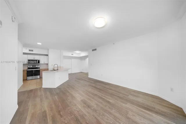 a view of kitchen with cabinets and wooden floor