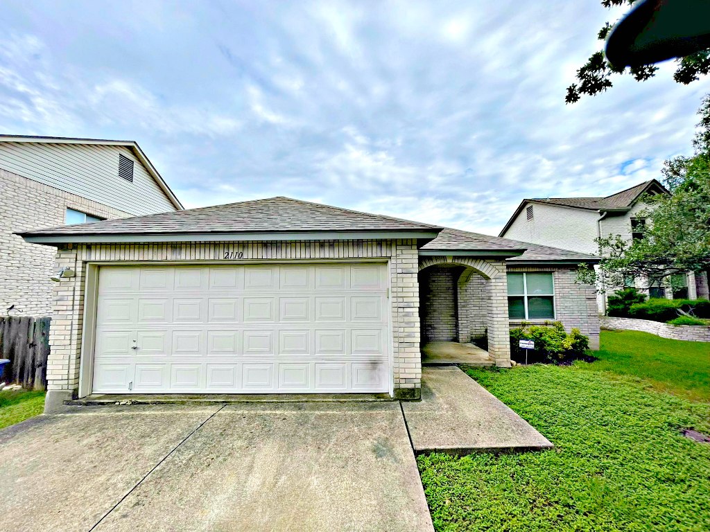 a front view of a house with garden