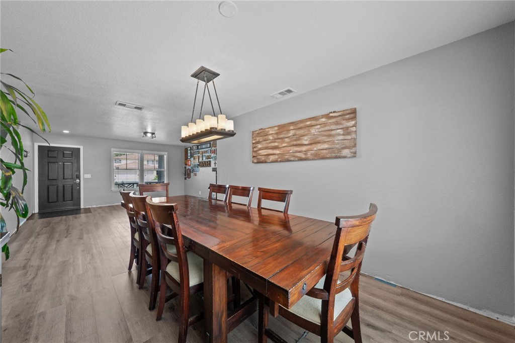 29266 Granite Ridge Court Menifee, CA 92587 - Photo 13 of 51 a view of a dining room with furniture window and wooden floor