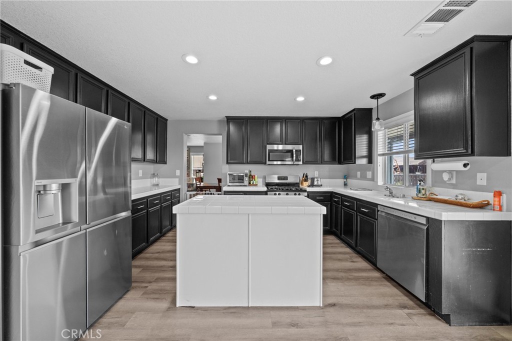 29266 Granite Ridge Court Menifee, CA 92587 - Photo 16 of 51 a kitchen with stainless steel appliances cabinets and a sink