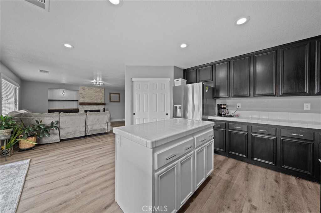 29266 Granite Ridge Court Menifee, CA 92587 - Photo 18 of 51 a kitchen with stainless steel appliances kitchen island granite countertop a stove and a refrigerator