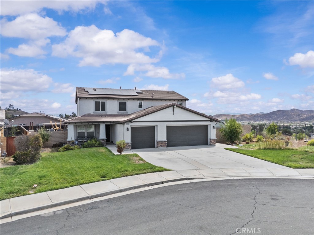 29266 Granite Ridge Court Menifee, CA 92587 - Photo 2 of 51 a front view of a house with a garden