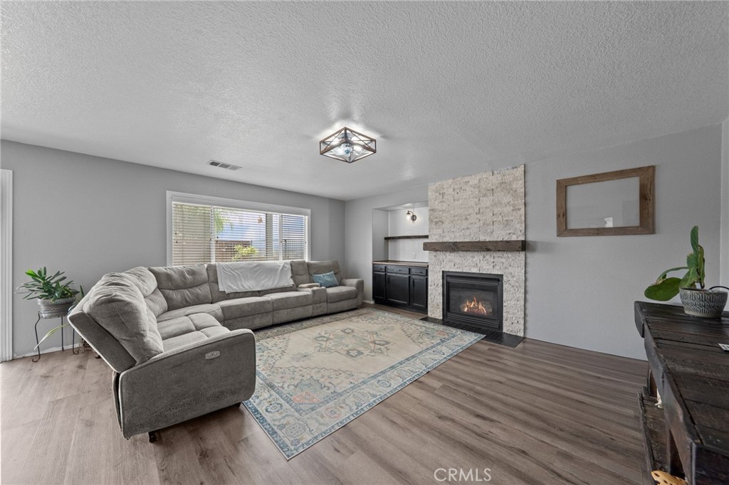 29266 Granite Ridge Court Menifee, CA 92587 - Photo 21 of 51 a living room with furniture and a fireplace