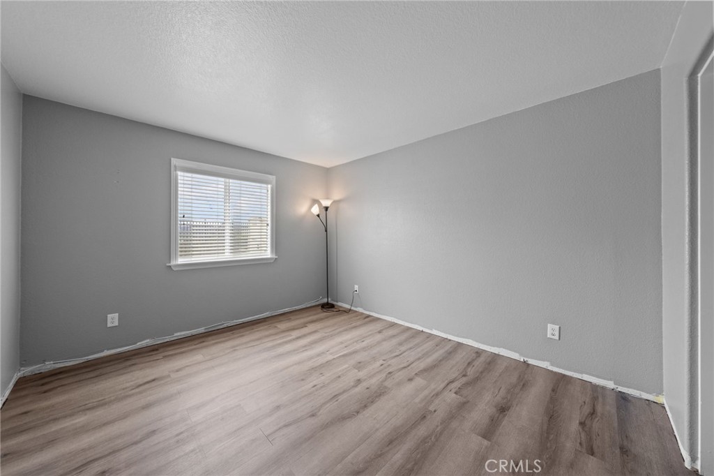 29266 Granite Ridge Court Menifee, CA 92587 - Photo 23 of 51 an empty room with wooden floor and windows