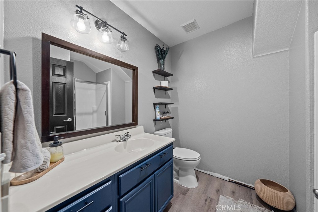 29266 Granite Ridge Court Menifee, CA 92587 - Photo 24 of 51 a bathroom with a granite countertop sink a toilet and a mirror