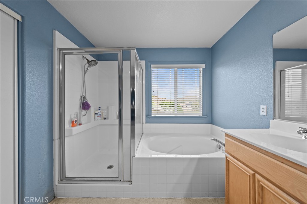 29266 Granite Ridge Court Menifee, CA 92587 - Photo 29 of 51 a bathroom with a bathtub and a shower