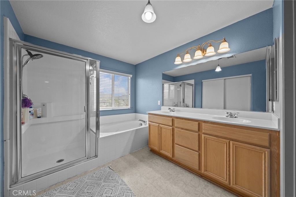 29266 Granite Ridge Court Menifee, CA 92587 - Photo 30 of 51 a spacious bathroom with a tub sink and mirror