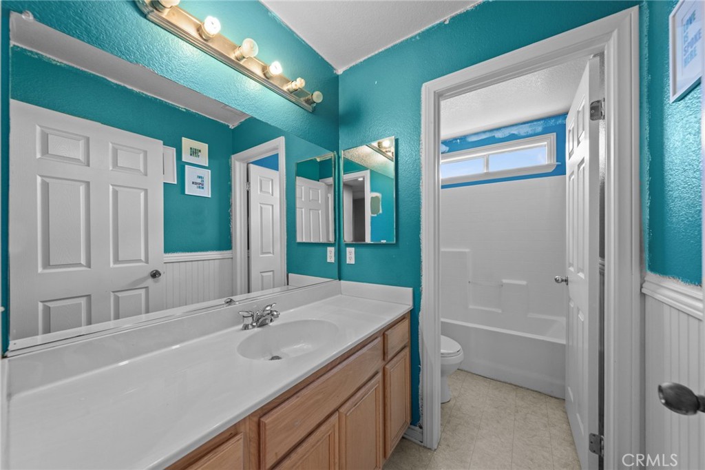 29266 Granite Ridge Court Menifee, CA 92587 - Photo 32 of 51 a bathroom with a tub a sink and mirror