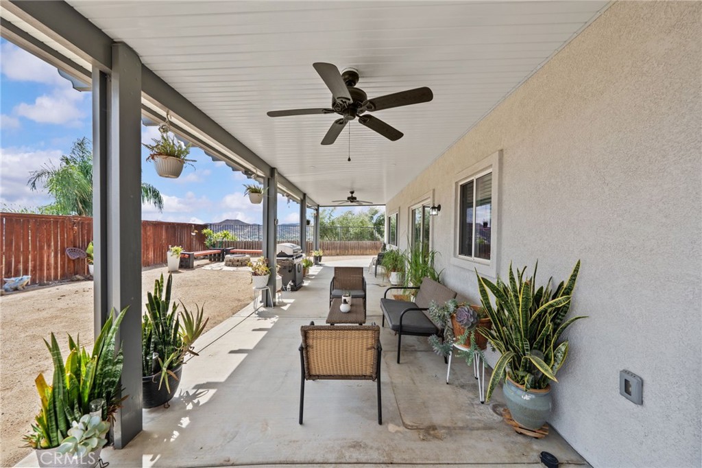 29266 Granite Ridge Court Menifee, CA 92587 - Photo 39 of 51 a living room with furniture ceiling fan and a large window