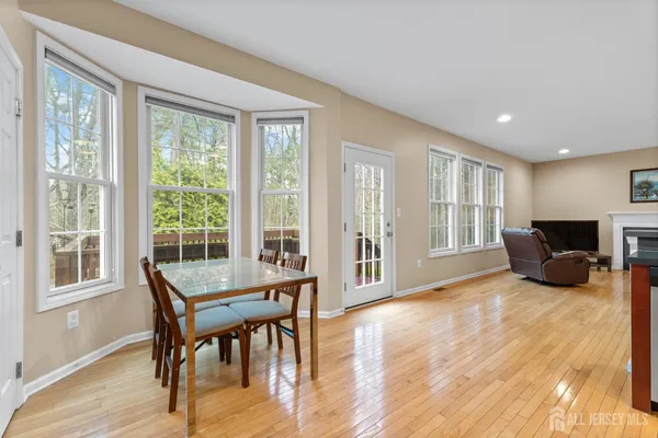 a large kitchen with stainless steel appliances granite countertop a lot of counter space and a wooden floor