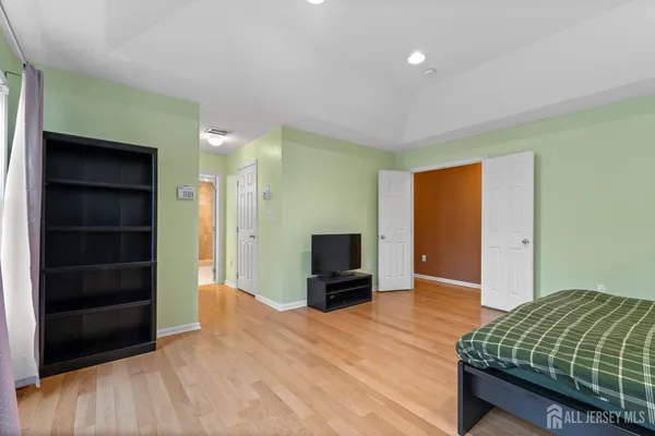 a spacious bathroom with a tub sink and mirror